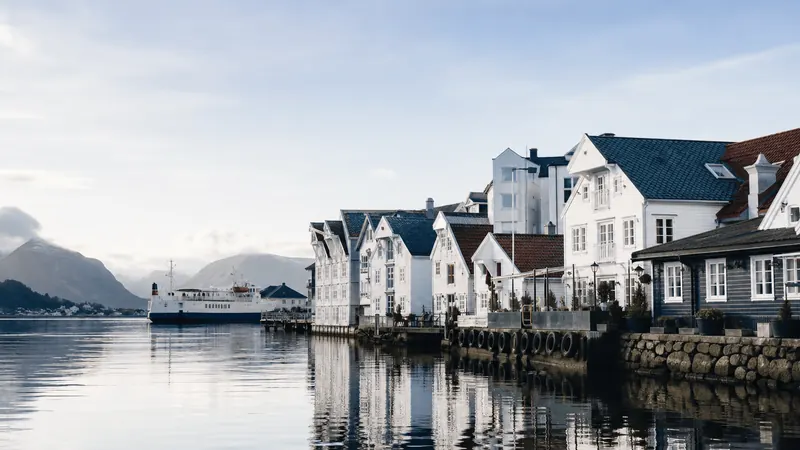 White wooden houses reflected in a calm northern harbour